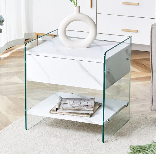 Bedside Table With Drawers. The Board Surface Is MDF Sticker, And Both Sides Are Transparent Tempered Glass. The Design Is Simple And Elegant, With Excellent Storage Functions