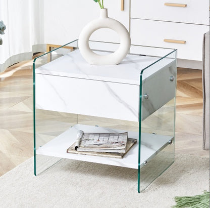 Bedside Table With Drawers. The Board Surface Is MDF Sticker, And Both Sides Are Transparent Tempered Glass. The Design Is Simple And Elegant, With Excellent Storage Functions